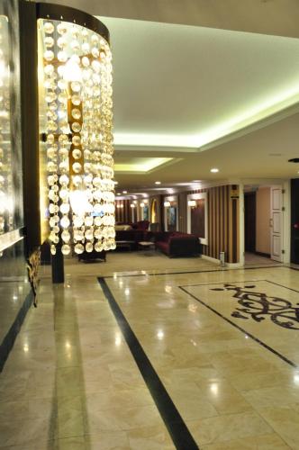 a large lobby with a large chandelier in a building at Royal Hotel Inegol in Inegol