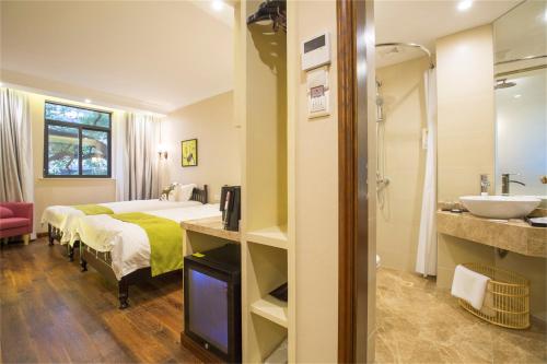 a hotel room with a bed and a sink at Shanghai Soho Garden Hotel in Shanghai