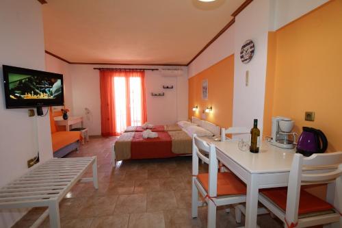 a living room with a room with a bed and a table at Aris Studios in Hersonissos