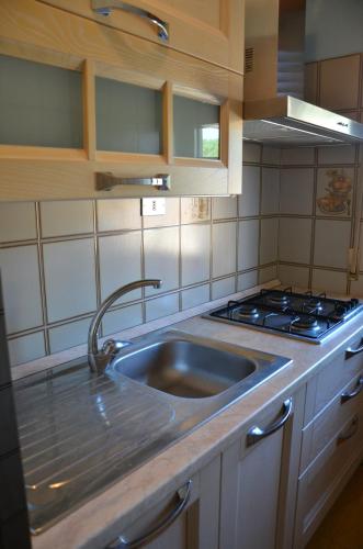 kuchnia ze zlewem i kuchenką w obiekcie Vacanze Sardegna Mare San Giovanni Posada w mieście Posada