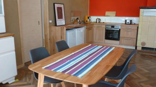 a kitchen with a wooden table with chairs around it at Alte Schule in Tambach-Dietharz