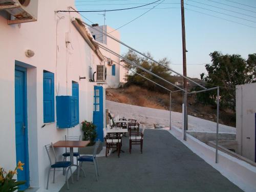 a balcony with tables and chairs on a building at Princess Sissy in Ios Chora