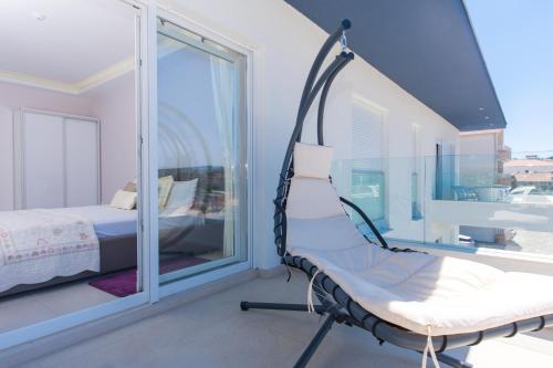 a swing in a room with a bed and a window at Apartments Soho in Trogir