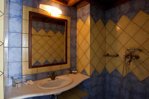 a bathroom with a sink and a mirror at Chateau Zevgoli in Naxos Chora