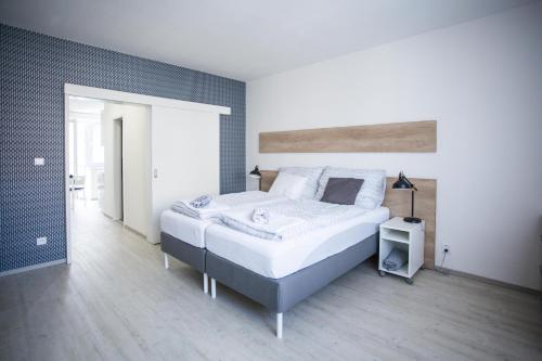 a bedroom with a large bed in a room at Haas Apartments in Brno