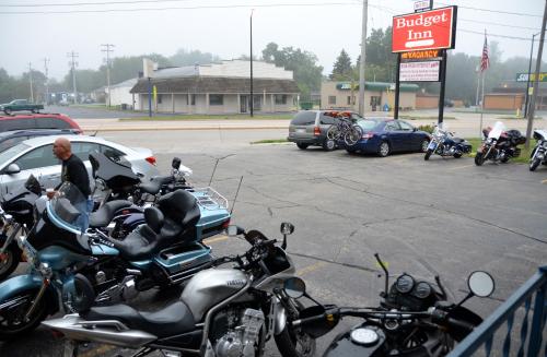 a group of motorcycles parked in a parking lot at Budget Inn Marinette in Marinette