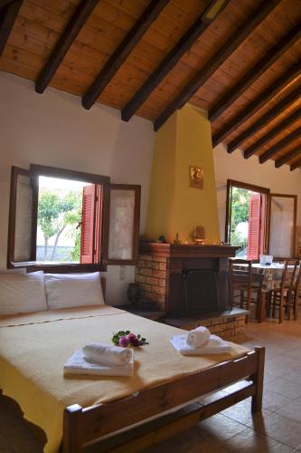 a bedroom with a bed with two towels on it at Chouchounikos Apartments in Lefokastro