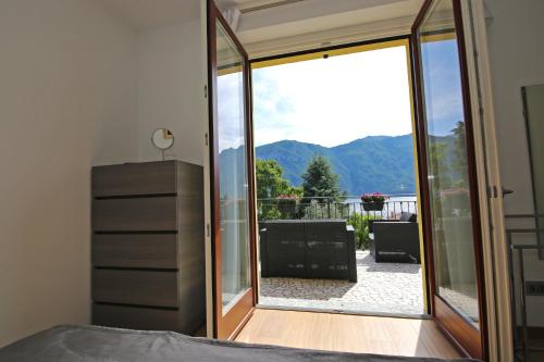 a bedroom with a large sliding glass door to a patio at Casa Ketty in Bellagio
