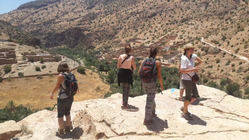 a group of people standing on top of a mountain at Oasis de Tiout in Tiout