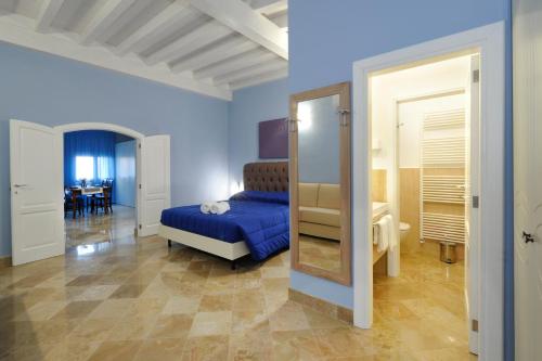 a bedroom with a bed and a mirror at Palazzo Massari in Lecce