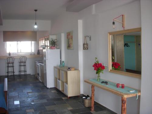a kitchen with a table and a refrigerator at Seascape Apartment in Faliraki