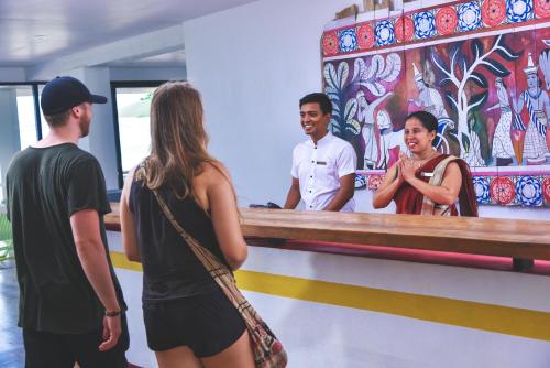 a group of people standing in front of a counter at Coral Rock by Bansei in Hikkaduwa