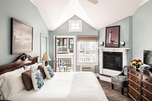 a bedroom with a bed and a fireplace at Crowne Pointe Historic Inn Adults Only in Provincetown