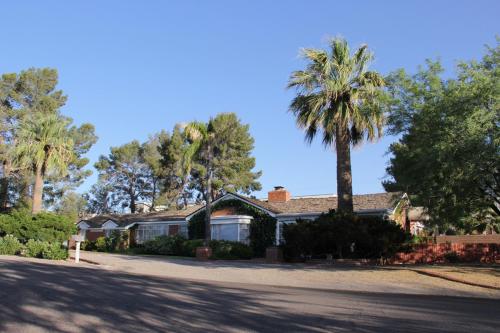 a house with a palm tree in the driveway at Mon Ami Bed and Breakfast in Tucson