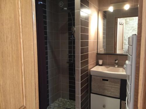 een badkamer met een wastafel en een spiegel bij L'océane in Le Pouliguen
