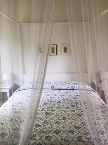 a bed with a canopy in a bedroom at Casali Romei in Sarzana