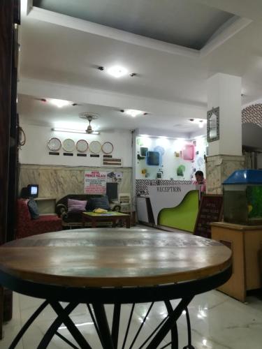 a table in the middle of a room at Hotel Prince Palace (The Green) in New Delhi
