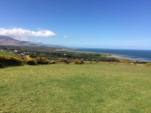 a field of grass with the ocean in the background at Coach Field Camp in Camp