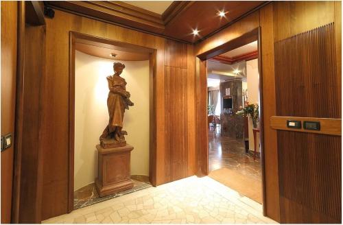 a statue of a woman on a wall in a hallway at Hotel Arcadia in Florence