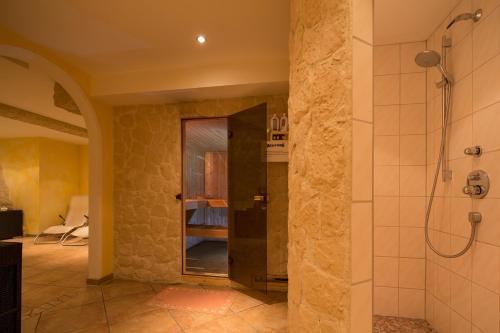 a bathroom with a shower and a walk in shower at T3 Alpenhotel Garfrescha in Sankt Gallenkirch