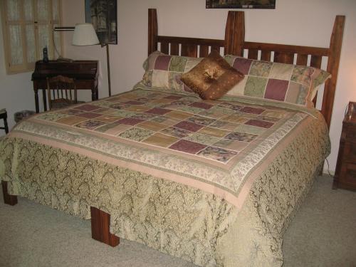 a bedroom with a bed with a quilt on it at Mon Ami Bed and Breakfast in Tucson