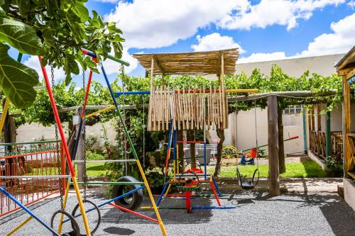a playground in a yard with a swing at Hazeldene Accommodation in Colesberg