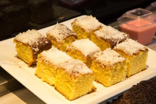 a white plate with many pieces of cake at Petit Rio Hotel in Rio de Janeiro
