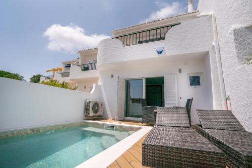 a villa with a swimming pool and a house at ATLANTIC VIEW Apartment in Luz