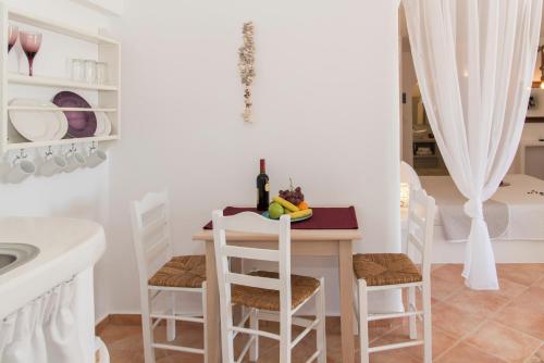 a kitchen with a table with chairs and a sink at Psilandis Studios in Adamas