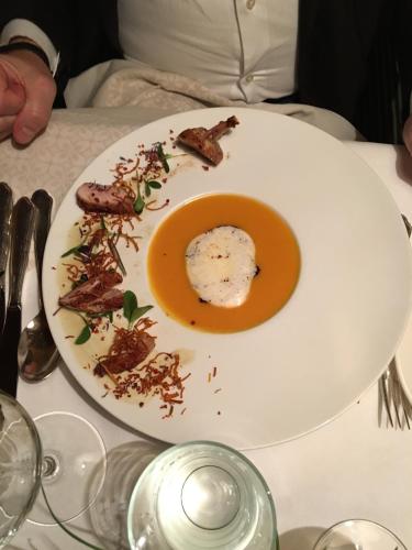 a white plate with food on a table at Hotel Restaurant Zur alten Gasse in Bellwald