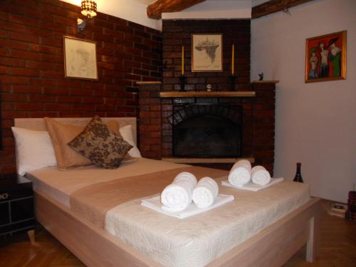 a bedroom with a bed with towels on it at Apartment Djukovic in Petrovac na Moru