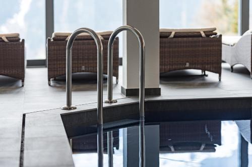 a row of metal handles on a table in a restaurant at Hotel Restaurant Zur alten Gasse in Bellwald