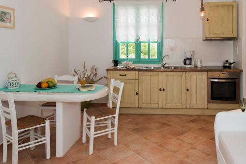 a kitchen with a table and chairs and a sink at Psilandis Studios in Adamas