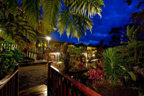 a night view of a house with trees and plants at Chalet Kilauea in Volcano