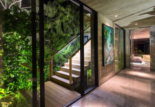 a house with glass doors and a staircase at Villa Islander in Providenciales