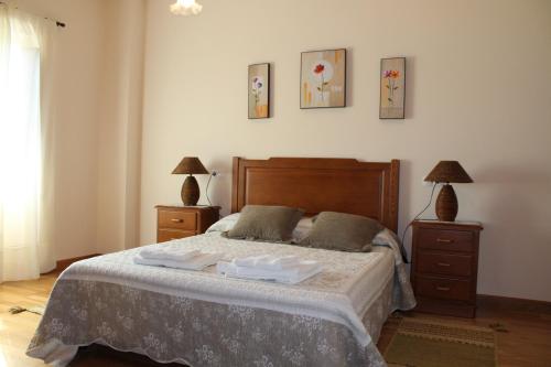 a bedroom with a bed with two towels on it at Apartamentos Casa Cerolleiro in Castropol