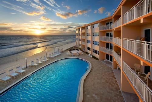 a view of a hotel with a swimming pool and the ocean at Paradise Beach Club - Ground Floor & Townhouses in Satellite Beach