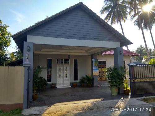 a small house with a garage at Relaxs Homestay in Kota Bharu