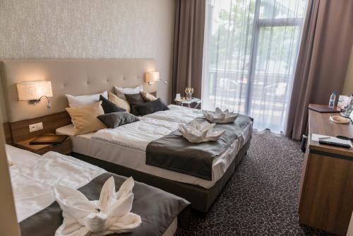 Postel nebo postele na pokoji v ubytování Hotel Thermalpark