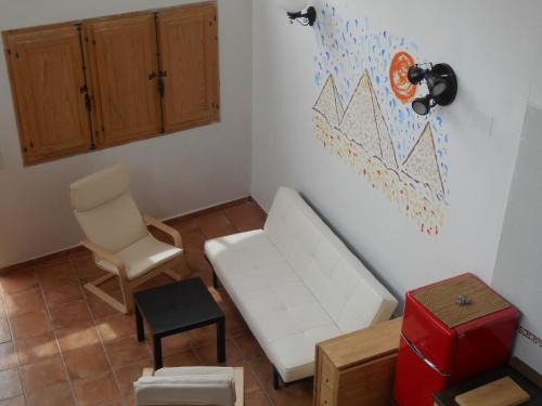 a living room with a white couch and a chair at Casa Isabel in Olvés