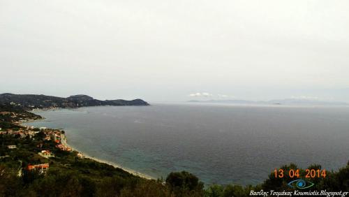 a view of the ocean from a hill at Hotel Pelagos Studios in Platána