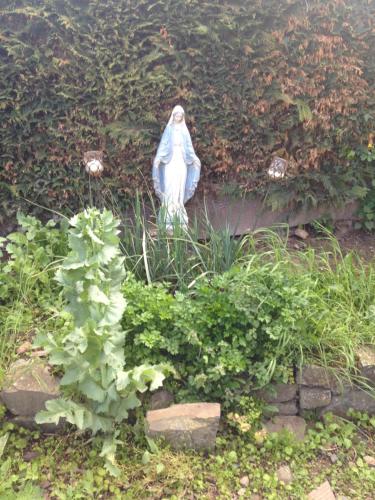 a statue of a woman sitting in a garden at Normandy Nature Paradise in Vire