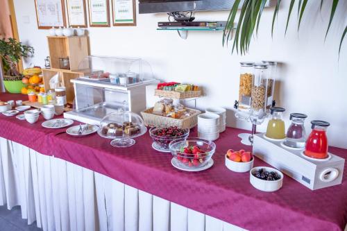 a table with food on a purple table cloth at Villa Margherita in Cefalù
