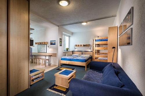 a living room with a couch and a bed at ALMET apartmánové štúdio 206 in Donovaly