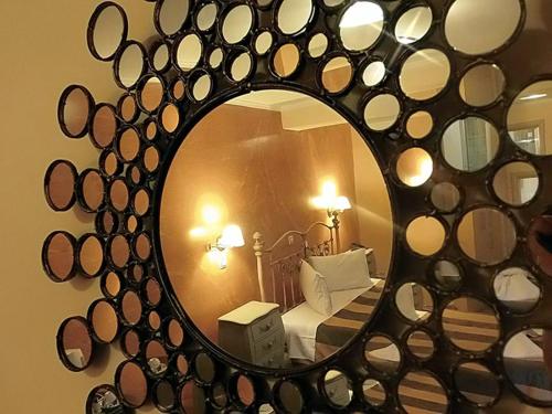 a mirror in a bedroom with a bed and a bed sqor at Hotel Anastazia in Póros Kefalonias