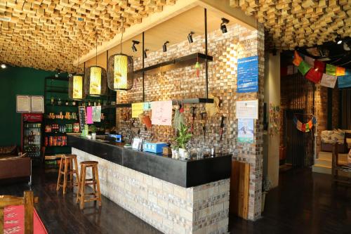 a bar in a restaurant with a brick wall at Huashan Lotus International Hostel in Huayin