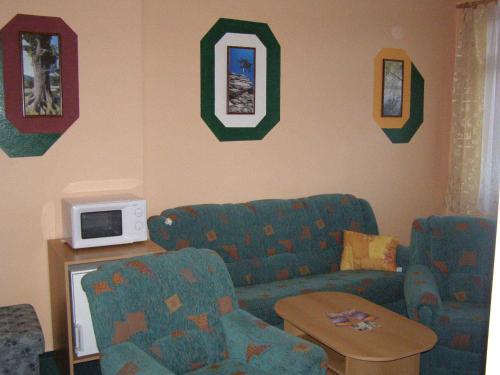 a living room with a couch and a table at Hotel Morava in Jevíčko