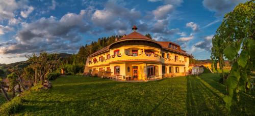 a large yellow house on a green field at Biolandhaus Arche in Eberstein