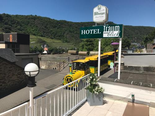 a yellow truck is parked at a hotel at Hotel Traumblick in Cochem