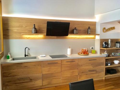 a kitchen with wooden cabinets and a sink at La Loggia Al Duomo - Treviso in Treviso